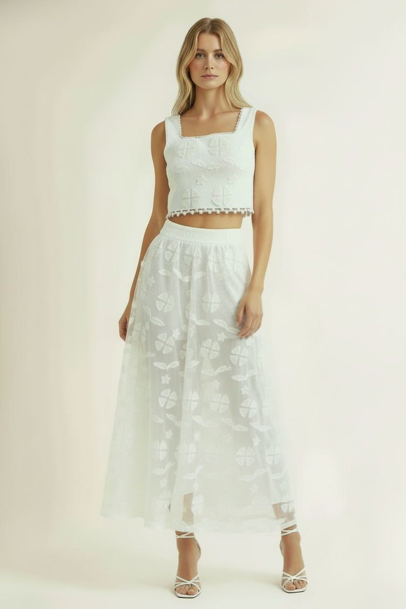 Elle Bridal Set – Sleek Wedding LookWoman wearing a white lace top and skirt set on a plain background