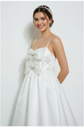 Lynda timeless bridal dress Woman wearing a white dress with a large bow on a white background