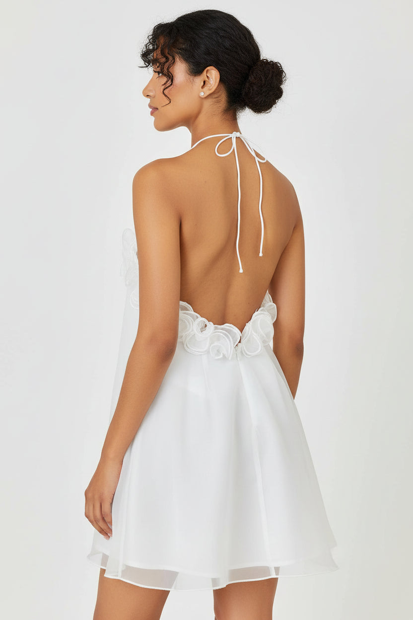 Marlee modern bridal dress Woman wearing a white dress with an open back on a plain background