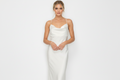 Nikki Bridal Dress – Modern Wedding Style Woman wearing a white dress on a plain background