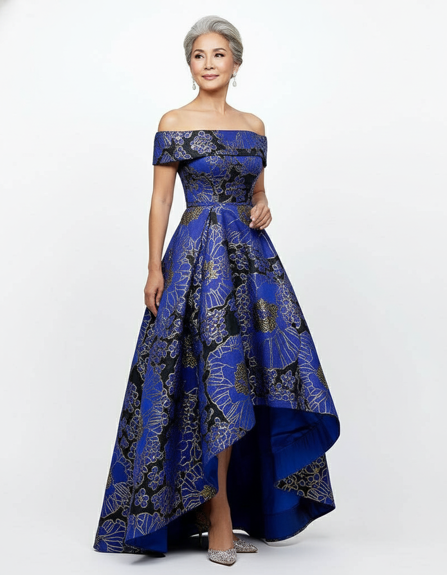 Reese mother of the bride dress Woman wearing a blue patterned off-shoulder gown on a white background
