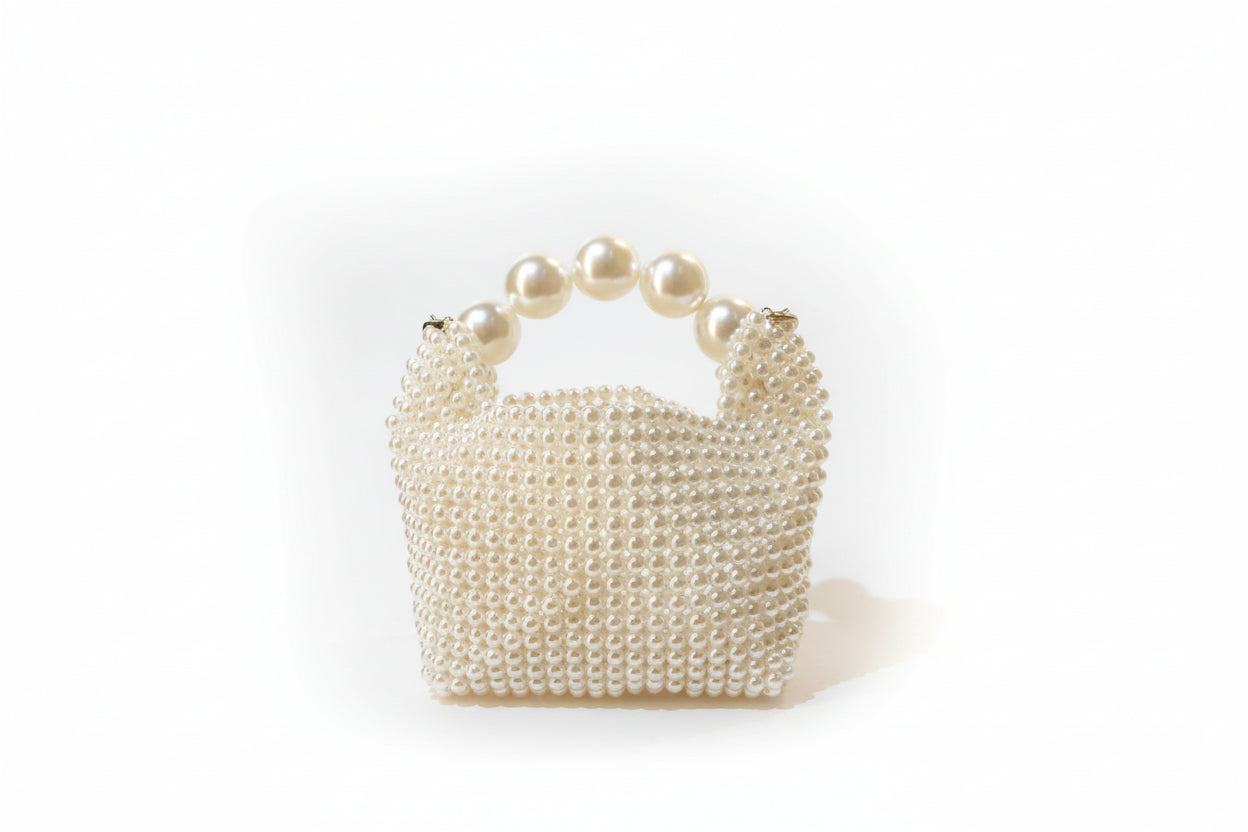 Pearl-handled handbag on a white background