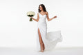 Samantha chic bridal dress Woman in a white wedding dress holding a bouquet on a white background