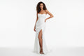 Savanna effortless bridal dress Woman wearing a strapless white gown with a slit on a white background