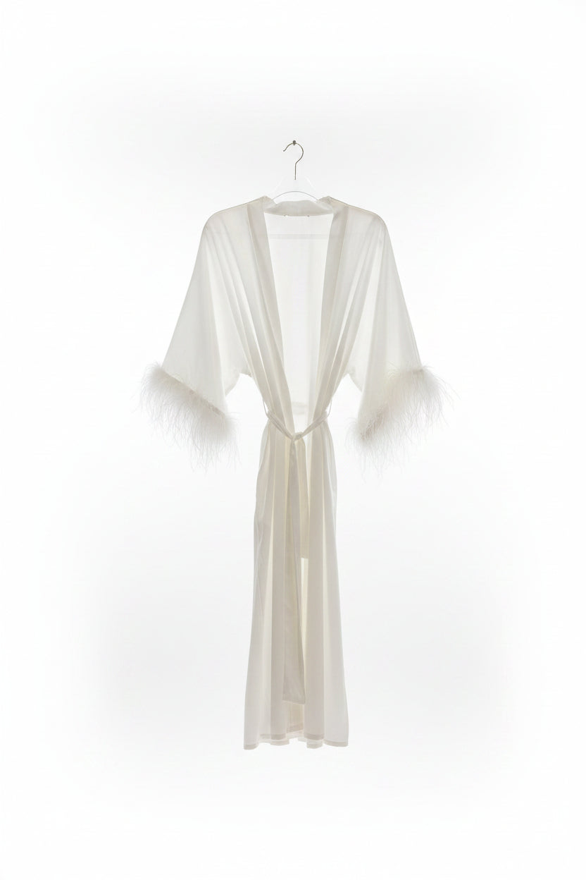 White robe on a hanger against a white background
