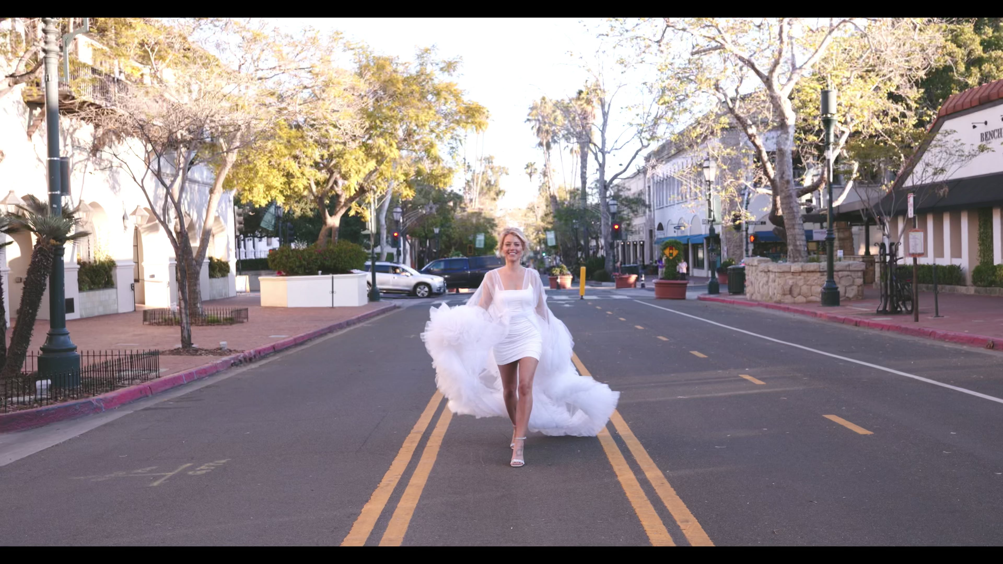 bride in robe walking down sate st