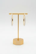 A pair of gold-colored hoop earrings with pearl embellishments, displayed against a white background.