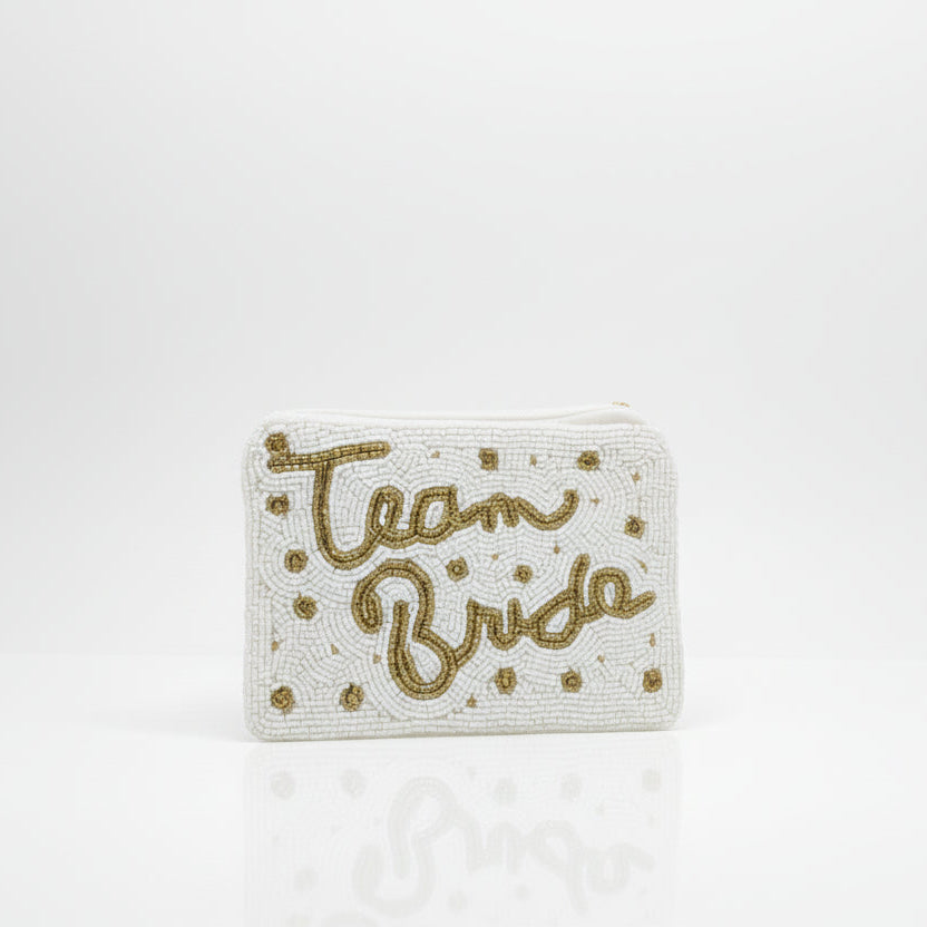 A gold and white beaded coin purse with the word 'TEAM' and 'BRIDE' written in a large, decorative font, secured with a metallic clasp.